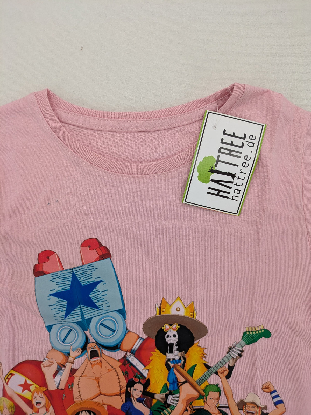 One Piece pink graphic tee featuring colorful Straw Hat crew print and classic fit.