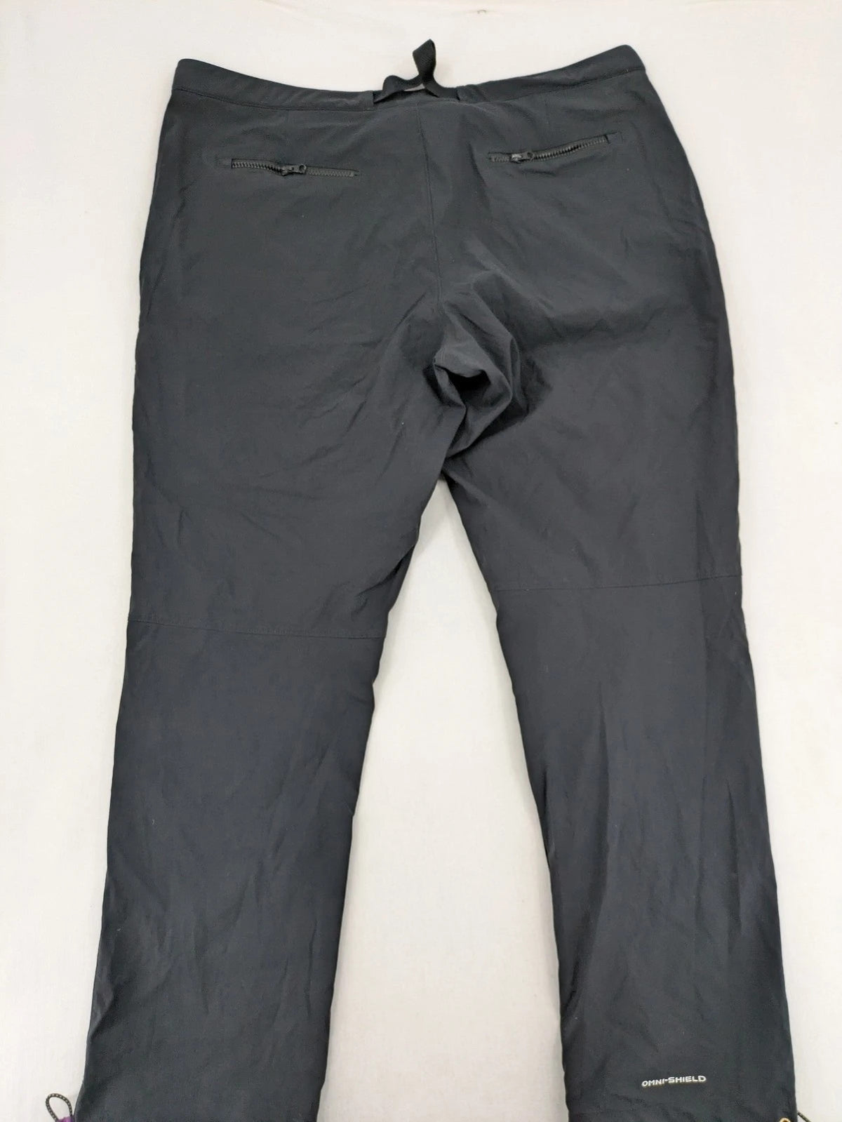 Columbia black trousers with Omni-Shield technology and contrasting purple details.