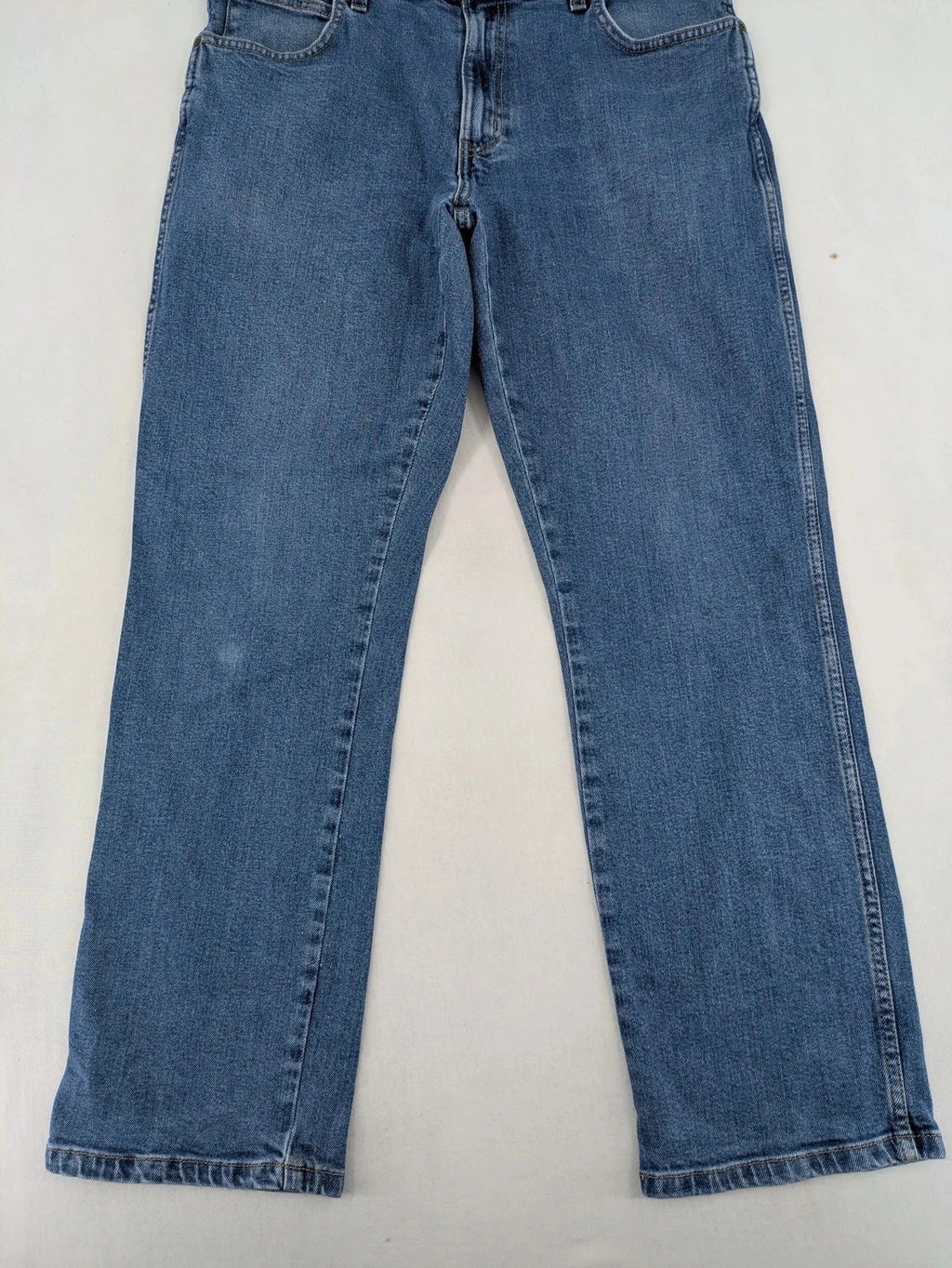 Wrangler blue straight jeans with classic wash and durable cotton-stretch blend.