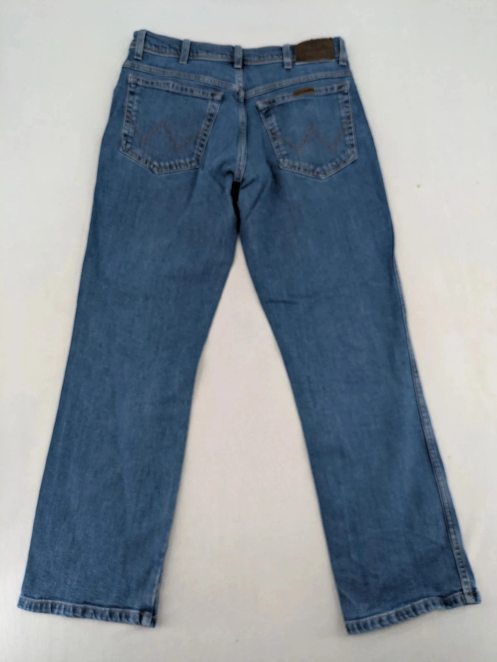 Wrangler blue straight jeans with classic wash and durable cotton-stretch blend.