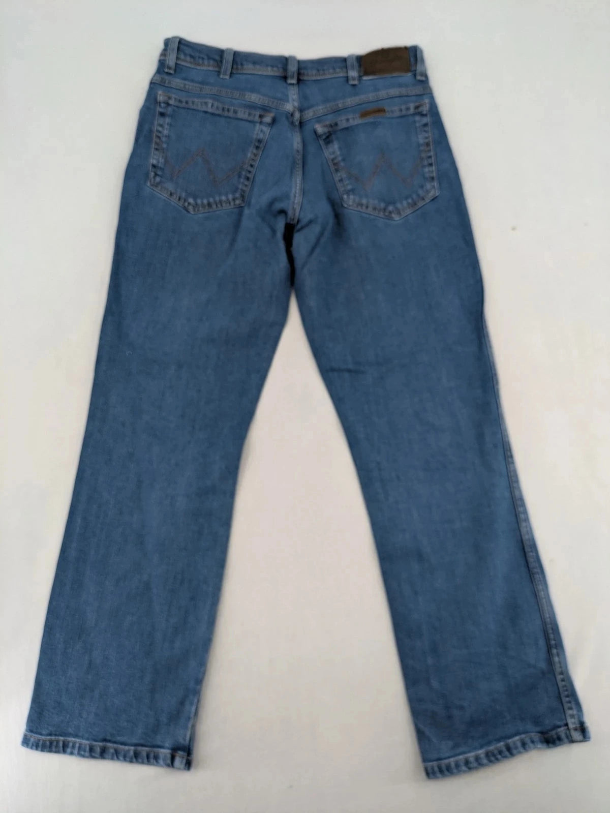 Wrangler blue straight jeans with classic wash and durable cotton-stretch blend.