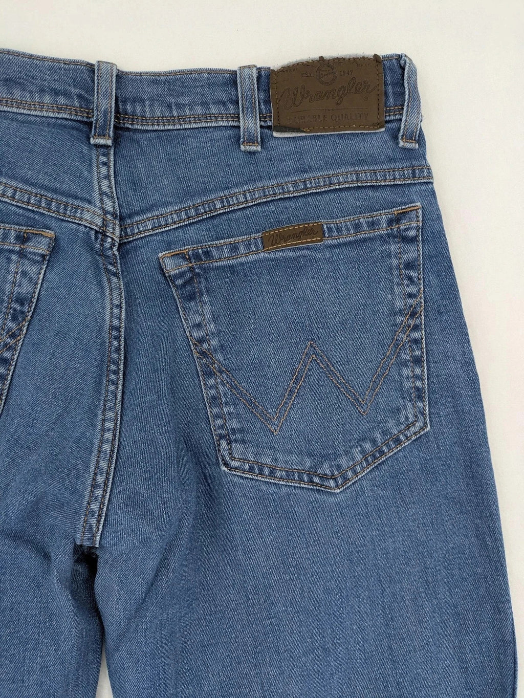 Wrangler blue straight jeans with classic wash and durable cotton-stretch blend.