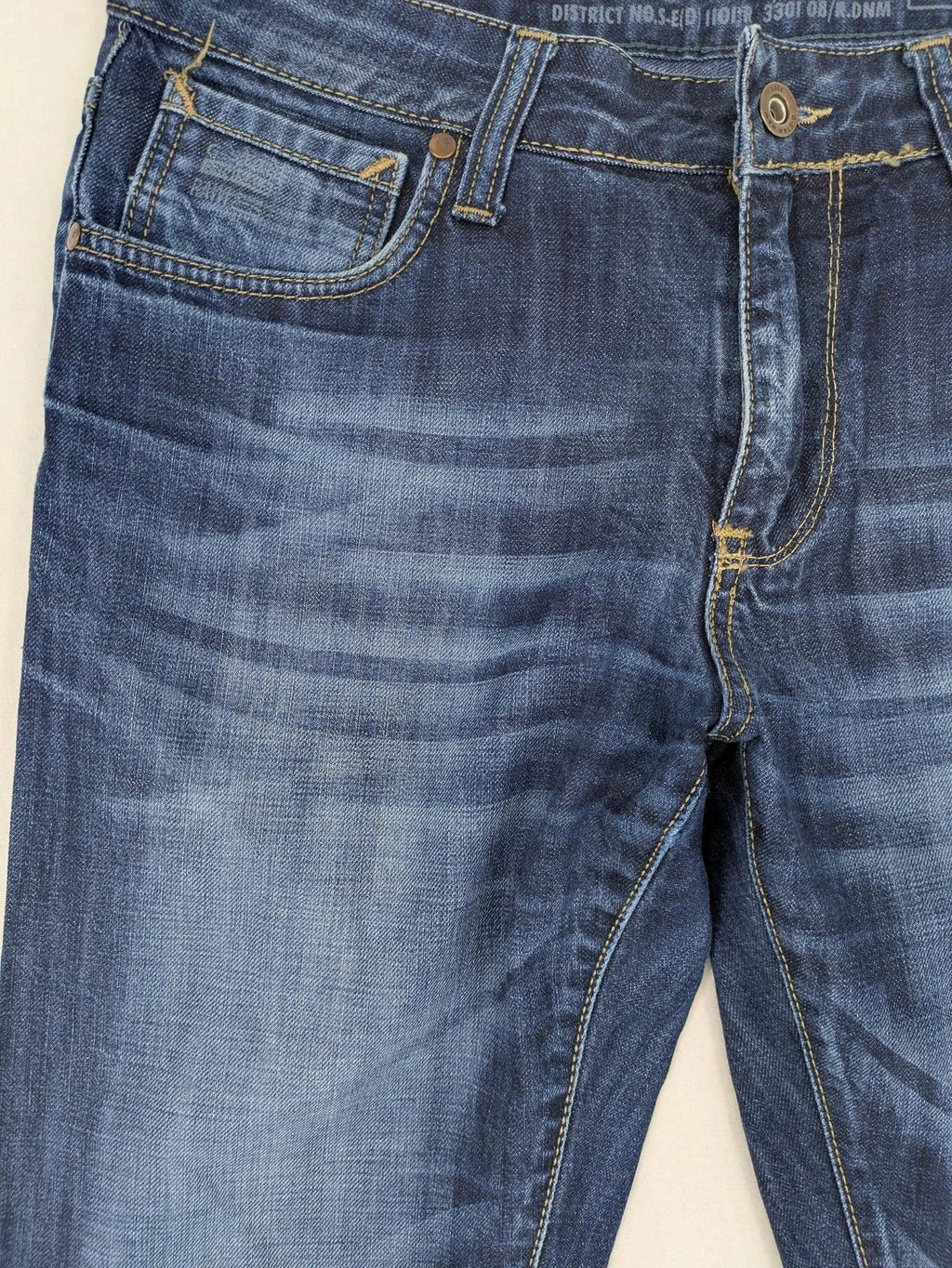 G-Star blue straight jeans with faded wash and whiskering effects, durable denim material.