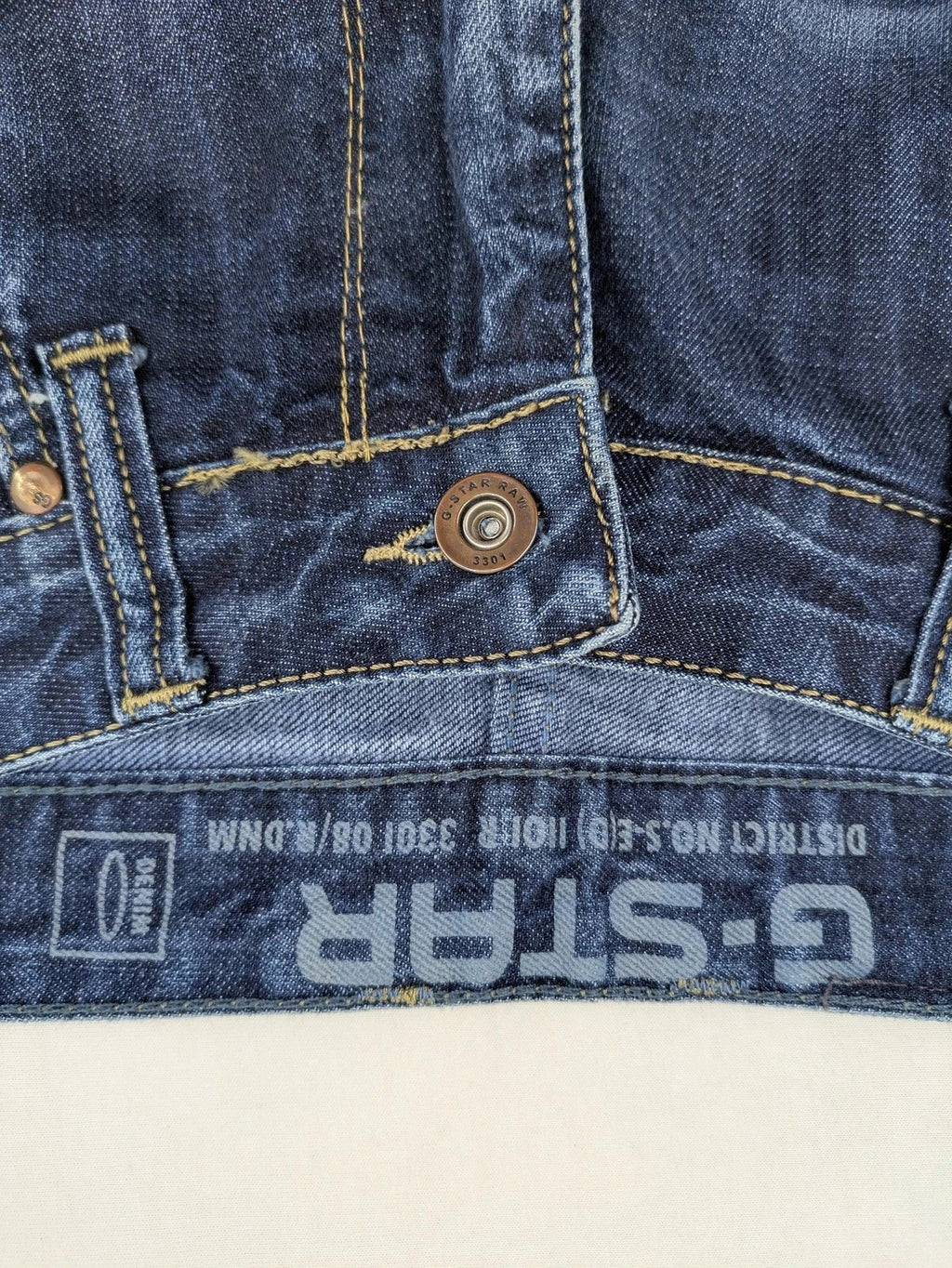 G-Star blue straight jeans with faded wash and whiskering effects, durable denim material.