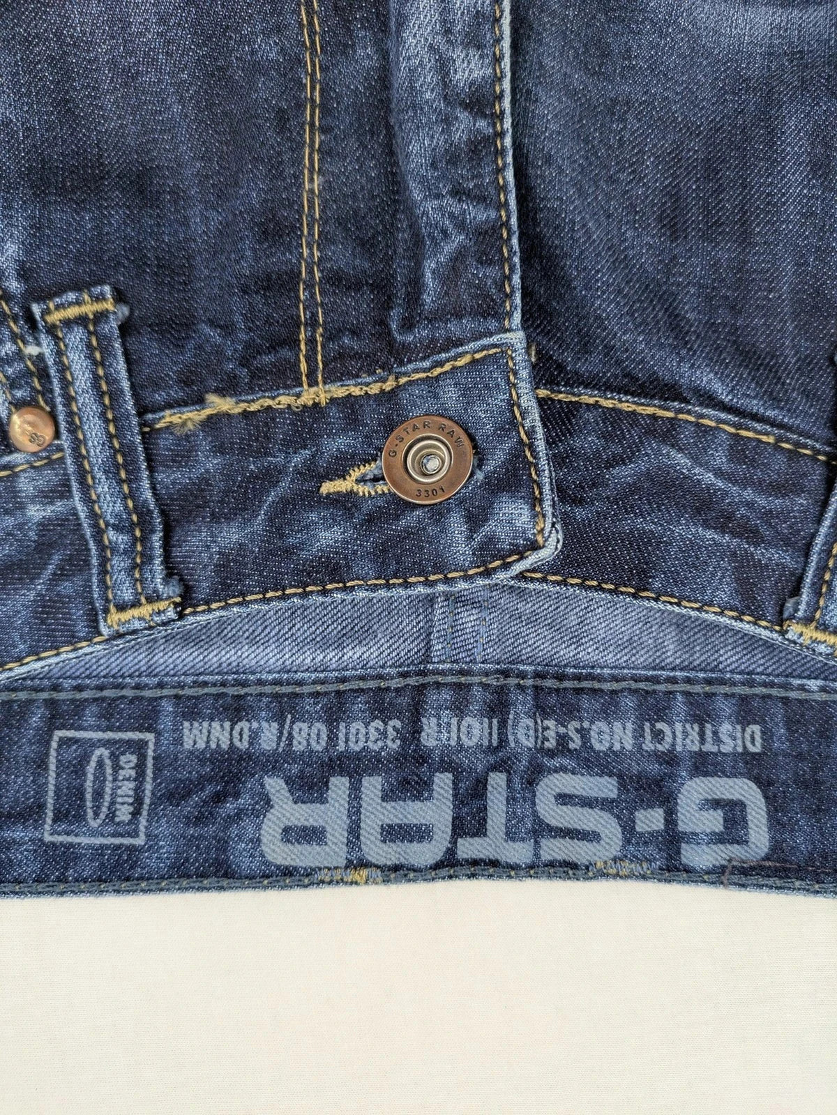 G-Star blue straight jeans with faded wash and whiskering effects, durable denim material.