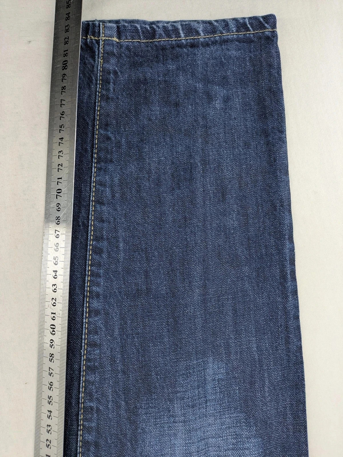 G-Star blue straight jeans with faded wash and whiskering effects, durable denim material.