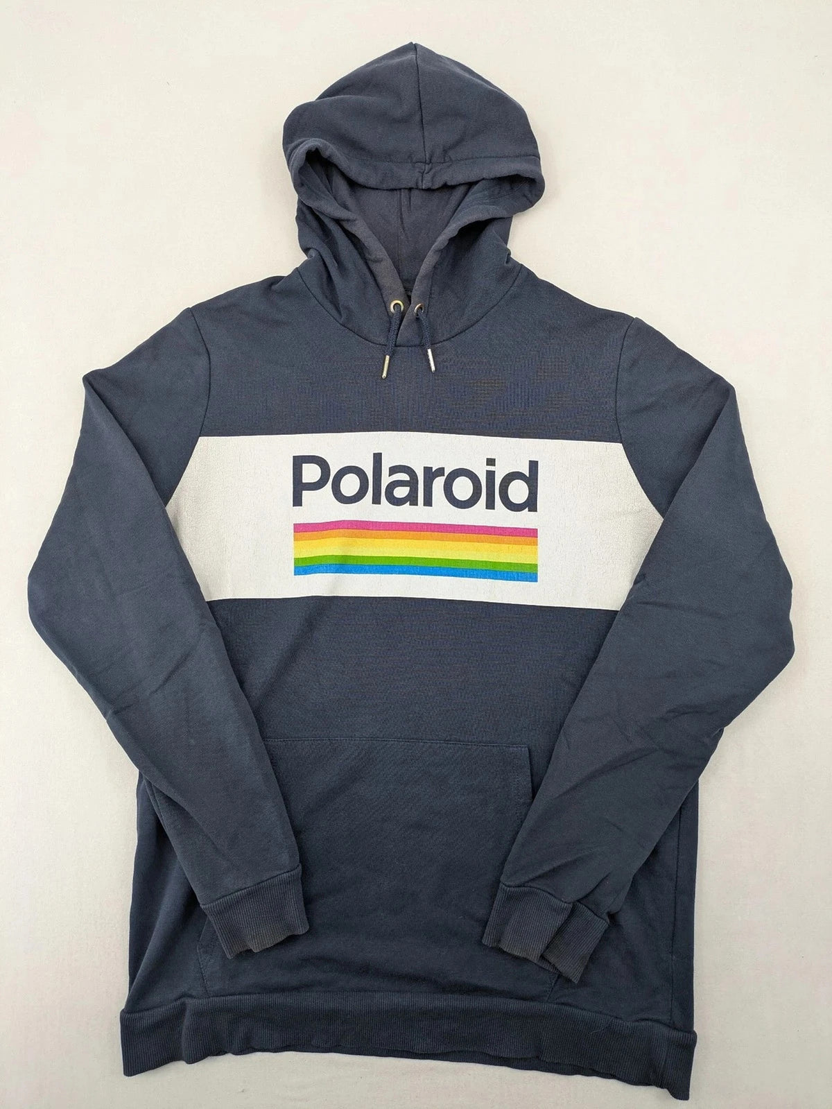 Polaroid blue graphic hoodie featuring iconic logo print with rainbow stripes and kangaroo pocket.