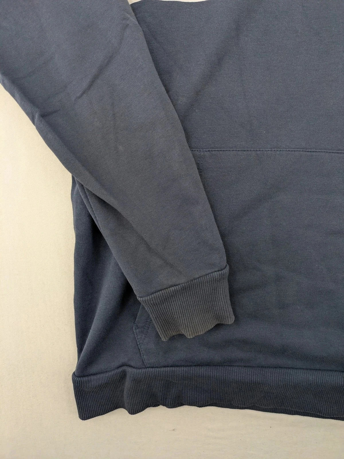Polaroid blue graphic hoodie featuring iconic logo print with rainbow stripes and kangaroo pocket.