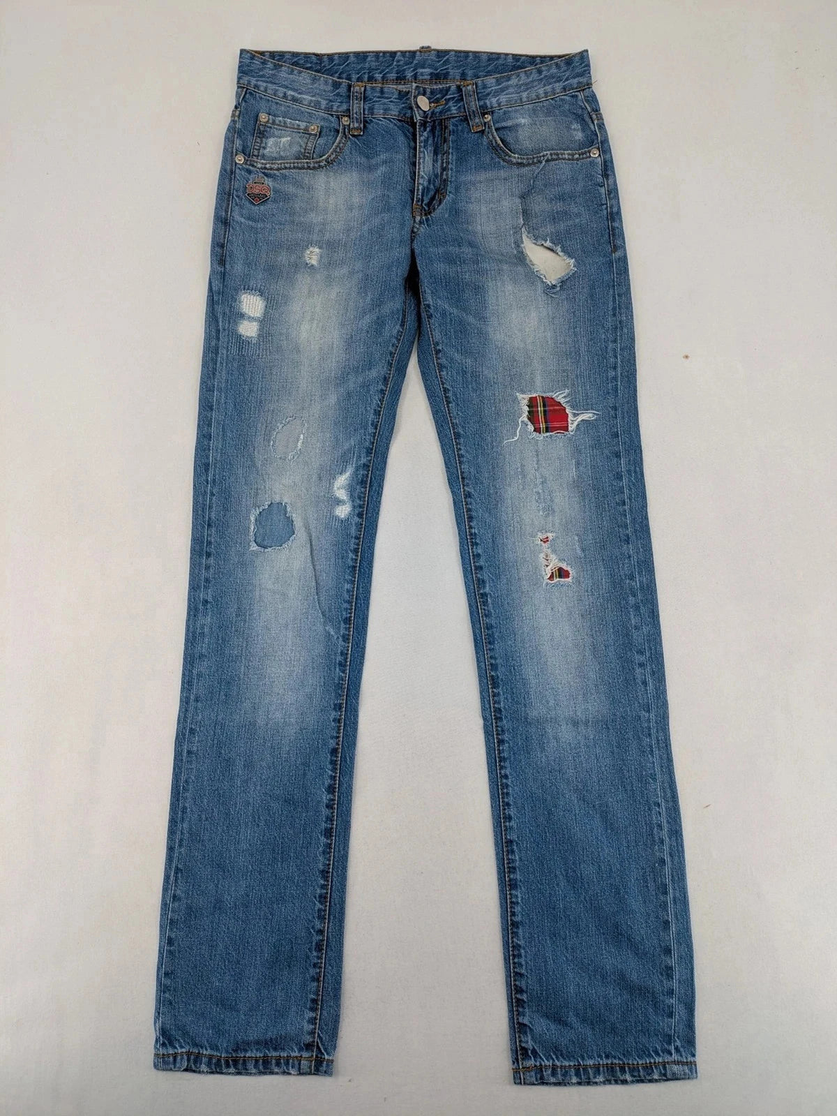 Andrew & Angel blue straight jeans distressed with red tartan patches and worn details.