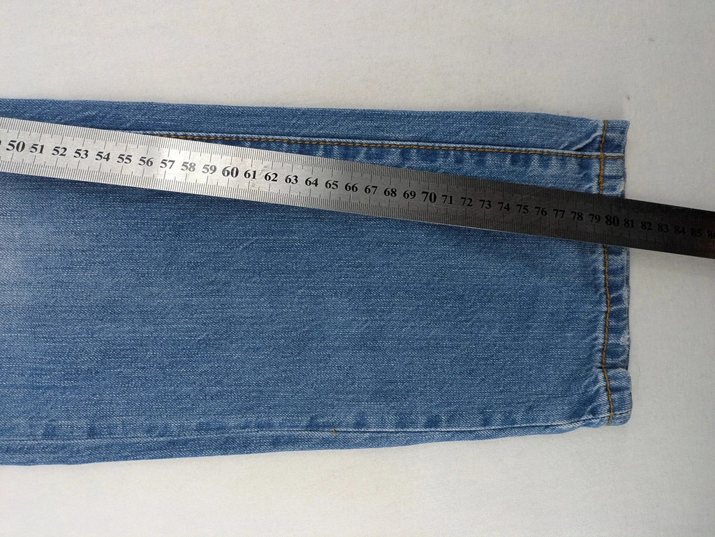 Andrew & Angel blue straight jeans distressed with red tartan patches and worn details.
