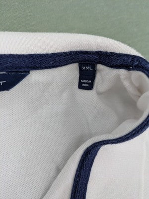 GANT white polo shirt with navy collar, embroidered logo on chest, piqué fabric.