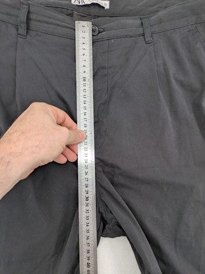 Zara grey chino pants with front pleats, rolled cuffs, and classic straight leg design.