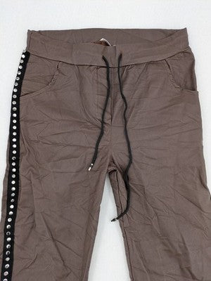 TREDY brown pants with black side stripes, silver studs, and adjustable drawstring.