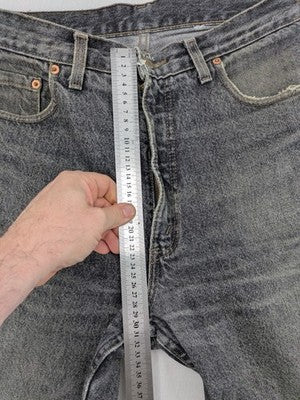 Levi's straight jeans faded black grey denim with iconic orange tab and five-pocket design.