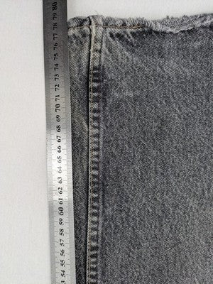 Levi's straight jeans faded black grey denim with iconic orange tab and five-pocket design.