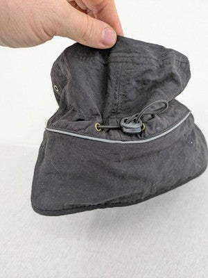 DHL green winter cap with reflective logo, ear flaps, and soft fleece lining.