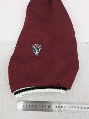 Burgundy dog sweater fleece lined with black and white striped trim, embroidered patch detail.