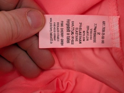 Pink Cherry pink jogpants with elastic waistband, decorative button placket, and rolled cuffs.