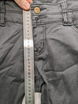 Damen grey coated skinny jeans with five-pocket design and gold hardware details.