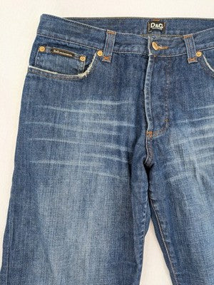 Dolce & Gabbana blue bootcut jeans with suede logo patch and classic 5-pocket design.
