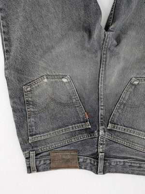 Levi's straight jeans faded black grey denim with iconic orange tab and five-pocket design.