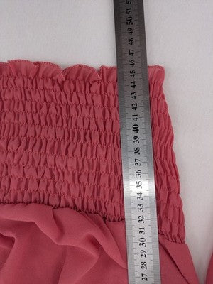 Melitea pink crop top with smocked waist and voluminous balloon sleeves.
