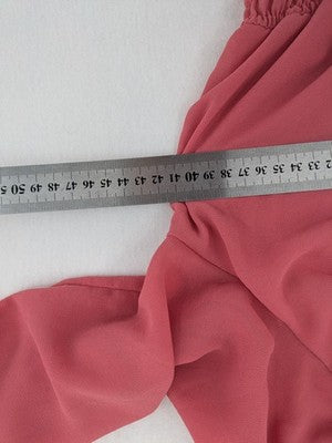 Melitea pink crop top with smocked waist and voluminous balloon sleeves.