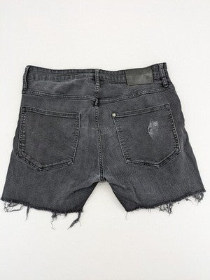 H&M black distressed skinny jeans shorts with frayed hem and button fly detail.