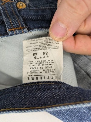 Dolce & Gabbana blue bootcut jeans with suede logo patch and classic 5-pocket design.