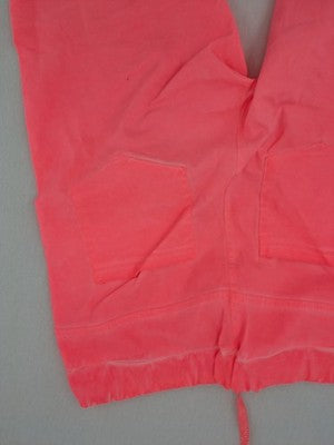 Pink Cherry pink jogpants with elastic waistband, decorative button placket, and rolled cuffs.