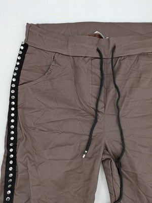 TREDY brown pants with black side stripes, silver studs, and adjustable drawstring.