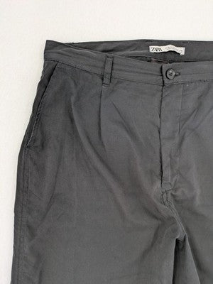 Zara grey chino pants with front pleats, rolled cuffs, and classic straight leg design.