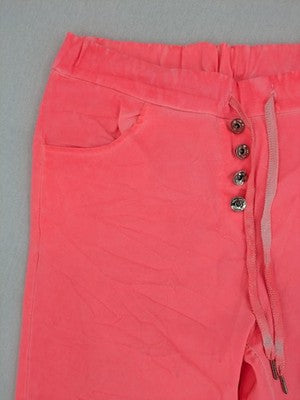 Pink Cherry pink jogpants with elastic waistband, decorative button placket, and rolled cuffs.