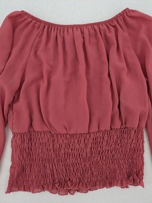 Melitea pink crop top with smocked waist and voluminous balloon sleeves.