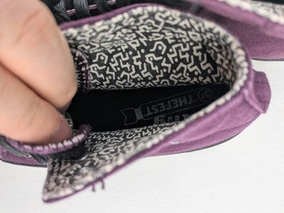 Mtng high top sneakers purple canvas with black laces and patterned white lining.
