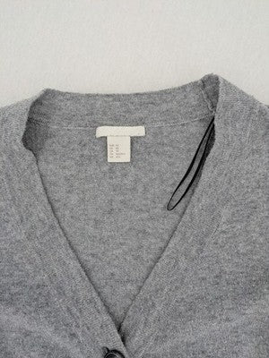 H&M grey cardigan with V-neck, button front, and layered ruffle sleeves.