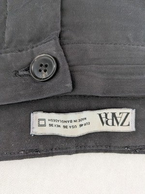 Zara grey chino pants with front pleats, rolled cuffs, and classic straight leg design.