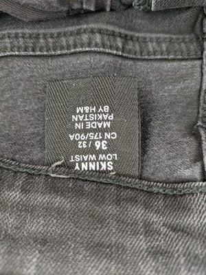 H&M black distressed skinny jeans shorts with frayed hem and button fly detail.