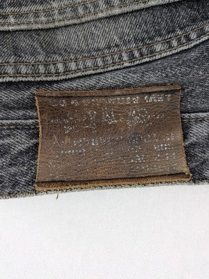 Levi's straight jeans faded black grey denim with iconic orange tab and five-pocket design.