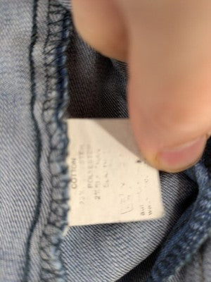 Select blue denim jacket with button closure and chest pockets, washed look.