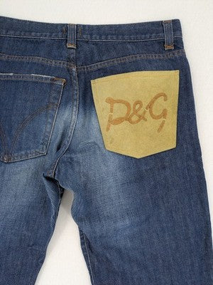 Dolce & Gabbana blue bootcut jeans with suede logo patch and classic 5-pocket design.