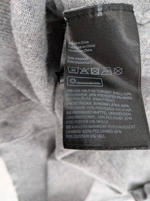 H&M grey cardigan with V-neck, button front, and layered ruffle sleeves.
