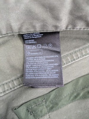 H&M khaki skinny fit jeans with classic five-pocket design and stretch cotton material.