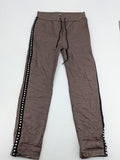 TREDY brown pants with black side stripes, silver studs, and adjustable drawstring.