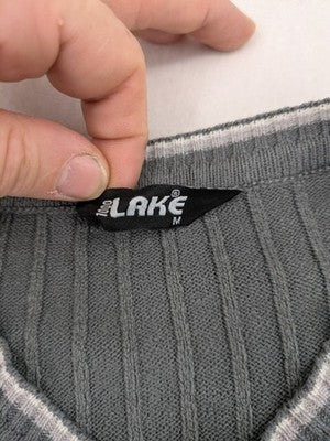 Elake grey knit jumper with V-neck, cable knit pattern and contrasting stripes.
