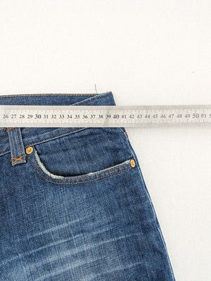 Dolce & Gabbana blue bootcut jeans with suede logo patch and classic 5-pocket design.