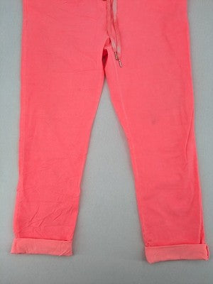 Pink Cherry pink jogpants with elastic waistband, decorative button placket, and rolled cuffs.