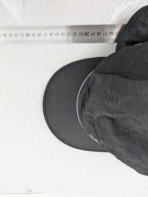 DHL green winter cap with reflective logo, ear flaps, and soft fleece lining.