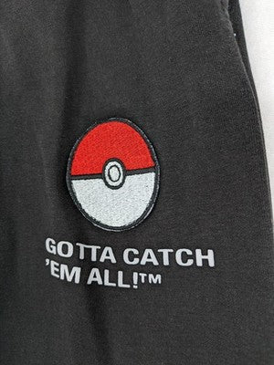 Herren grey jogging pants large Pokémon graphic print and embroidered Pokéball patch.
