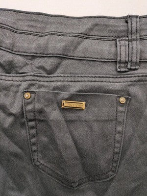 Damen grey coated skinny jeans with five-pocket design and gold hardware details.